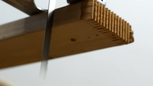 A carpenter cuts wood with an electric jigsaw. Repair work, wood sawing. 4K video close-up.