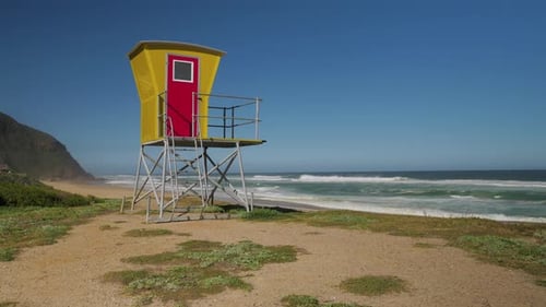 Colourful lifeguard tower overlooking secluded beach