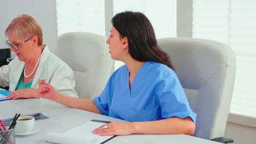Close Up of Medical Nurse Taking Notes on Clipboard During