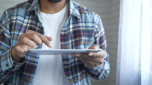 Adult Using Tablet Indoors During the Day