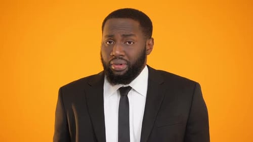 Unhappy African-American Office Employee Shrugging Shoulders and Feeling Guilty