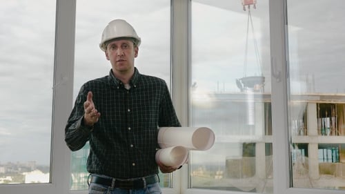 Mature engineer talking to camera explaining something.
