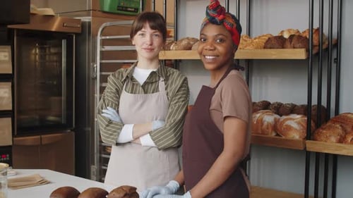 Portrait of Two Multiethnic Female Coworkers in Bakery
