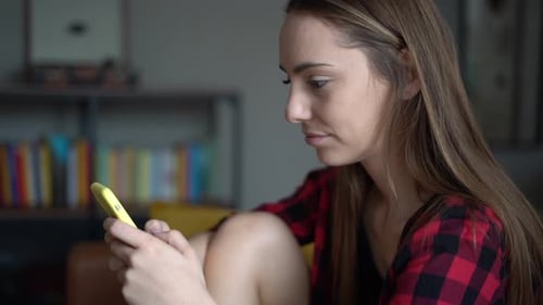 Woman Using Smartphone Indoors