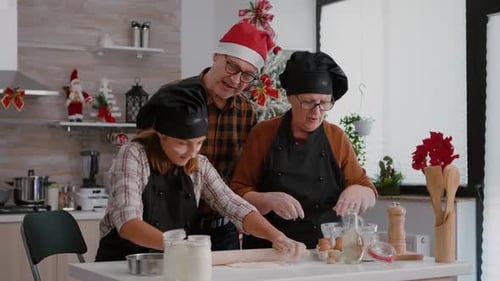 Family Baking Christmas Cookies Together in Kitchen