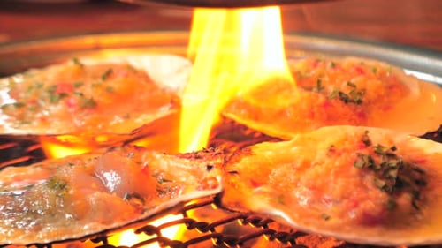 Big Fresh Scallop Shell Seafood Grill on Metal Net with Charcoal Barbecue in Korean Restaurant