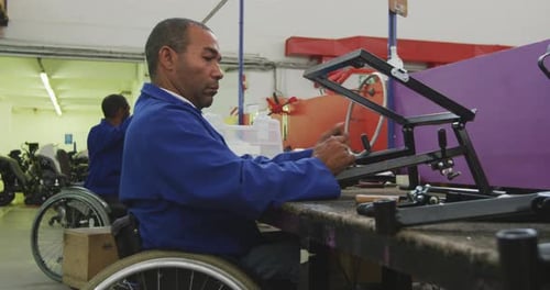 Workers Assembling Mobility Device Frames in Factory