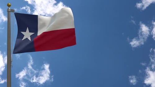 Texas Flag Waving in Blue Sky with Clouds