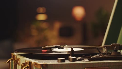 Vintage Record Player Spinning Black Vinyl at Night
