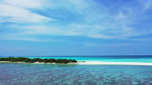 Wide angle fly over copy space shot of a sunshine white sandy paradise beach and aqua blue ocean bac