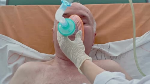 Doctor Places Oxygen Mask on Elderly Patient