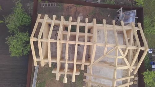 Top view of frame of wooden house under construction