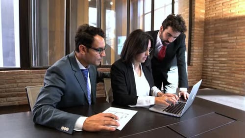 Team Collaborates on Building Design in Modern Office