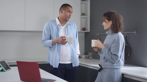 Couple Chatting Over Coffee in Modern Kitchen