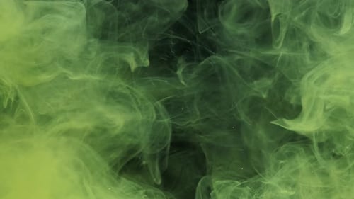 Green and Yellow Ink Acrylic Paint Mixing in Water Swirling Softly Underwater