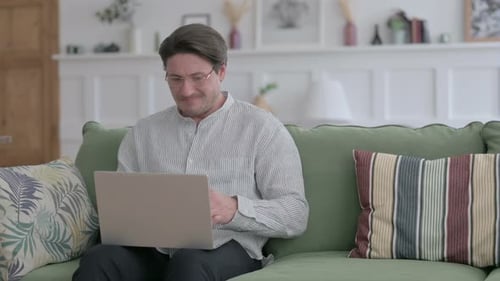 Man Working at Home Looks Frustrated