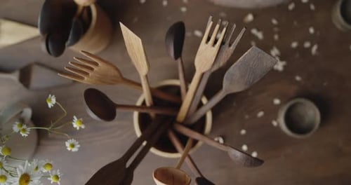 Wooden Cooking Utensils Gathered in a Bowl with Daisies