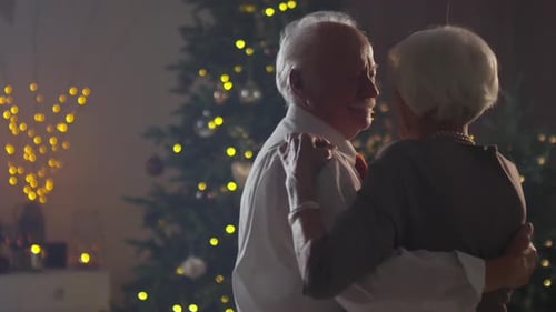 Loving Senior Couple Dancing Together at Christmas