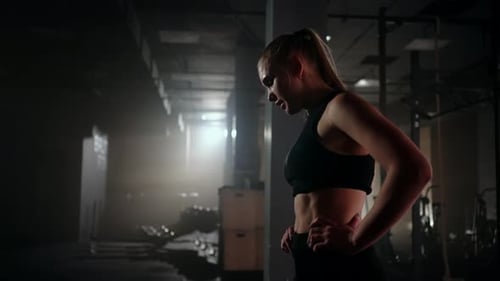 Exhausted Female Sportsperson in Gym After Training Power Workout for Keeping Fit and Health