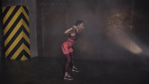 Athletic Beautiful Woman Doing Exercises in the Gym