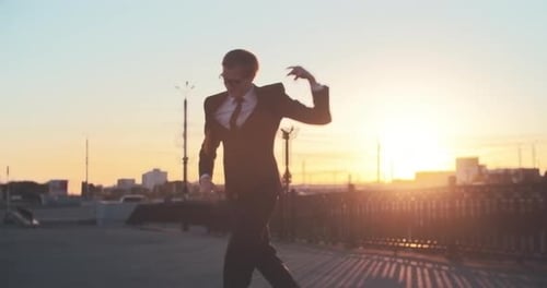 Young Adult Man Celebrates Triumphantly at Sunrise