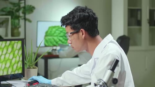 Scientist Working with Computer in Laboratory