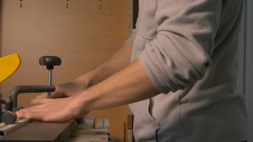 Carpenter pressing wood