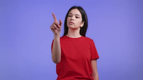 Woman Using Invisible Touchscreen on Violet Studio Background