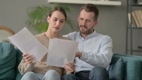 Couple Reviewing Documents Together at Home
