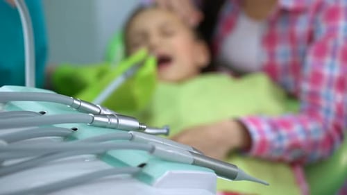 Little Boy Afraid of Dental Drill Treatment, Mother Soothing Child, Background