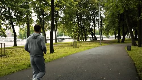 Back View of Man Running in Park
