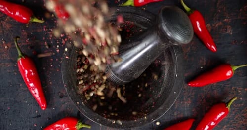 Peas of Black Pepper Falls Into the Mortar