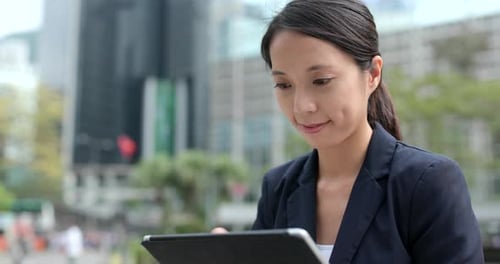 Woman Using Tablet in Urban Workplace Environment