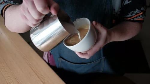 Barista Pouring Milk to Create Latte Art