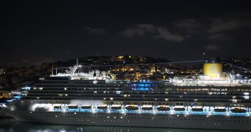 Aeial View. Big Cruise Ship with Lighted Lights Stands in the Port at Night