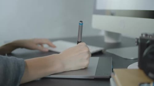 Creative Designer Using Graphic Tablet at Workplace