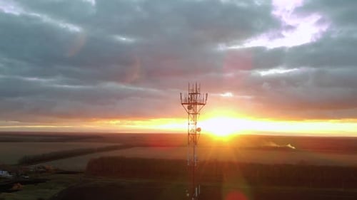 Aerial view to cellular tower with 5g internet antenna and 4g satellite dish.