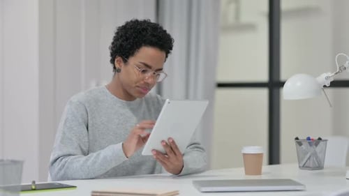 African Woman Using Tablet at Work