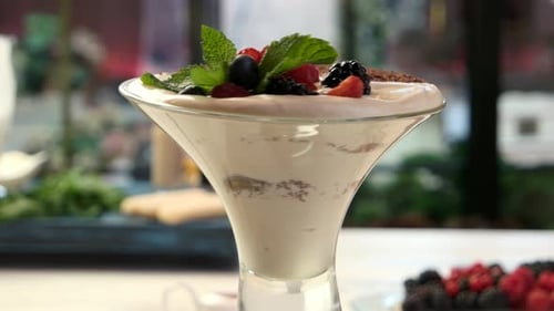 Cream Dessert with Berries in Glass