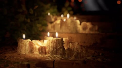 Flickering Candles with Melted Wax for Celebrations and Warm Ambiance