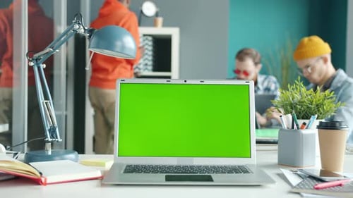 Slow Motion of Modern Laptop with Chroma Key Green Screen on Office Desk