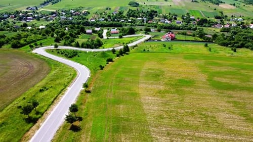 Aerial drone view of a flying over the rural agricultural landscape.