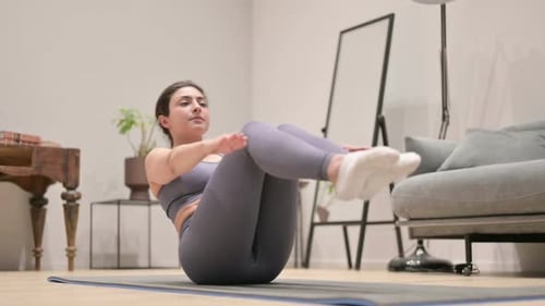 Woman Doing V-Up Exercise on Yoga Mat