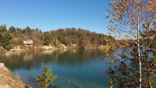 Drone View on Beautiful Deep Lake with Clear Turquoise Water and Beautiful Autumn Forest