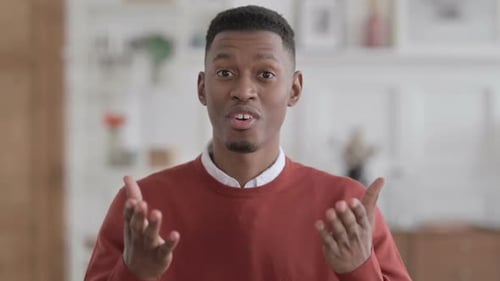 Young Adult Explaining and Gesturing Indoors