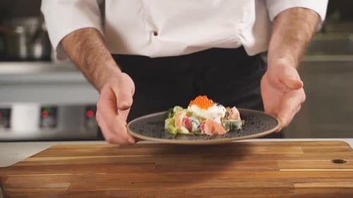 Chef Presents Salad Plate at Restaurant Kitchen
