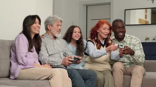 Joyful Family Playing Video Games on Couch