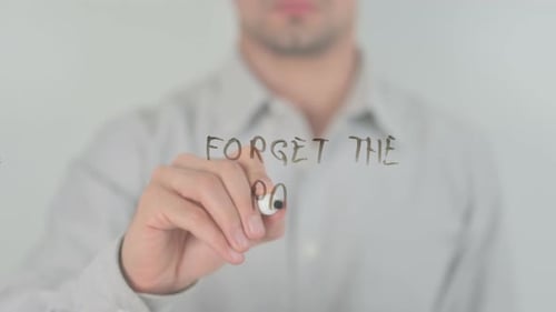 Man Writing Forget The Past on Screen