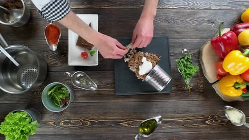 Chef Preparing Food Dish on Wooden Table