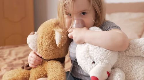 Child Using Nebulizer with Stuffed Animals